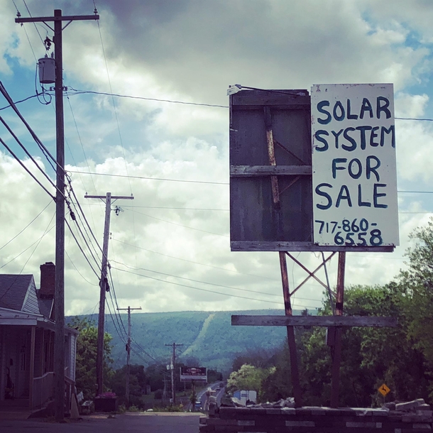 Rundown sign outside an abandoned store Selling our solar system  million OBO