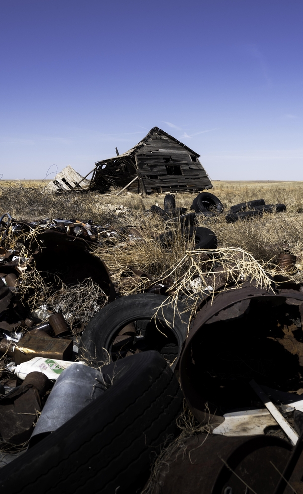 Rusting trash heap outside an old farmhouse Near Briggsdale Colorado 
