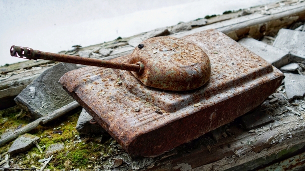 Rusty toy tank in the abandoned Childrens Hospital in Pripyat Chernobyl Exclusion Zone 