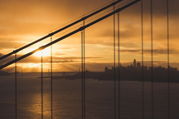 San Francisco skyline at sunrise through the Golden Gate Bridge