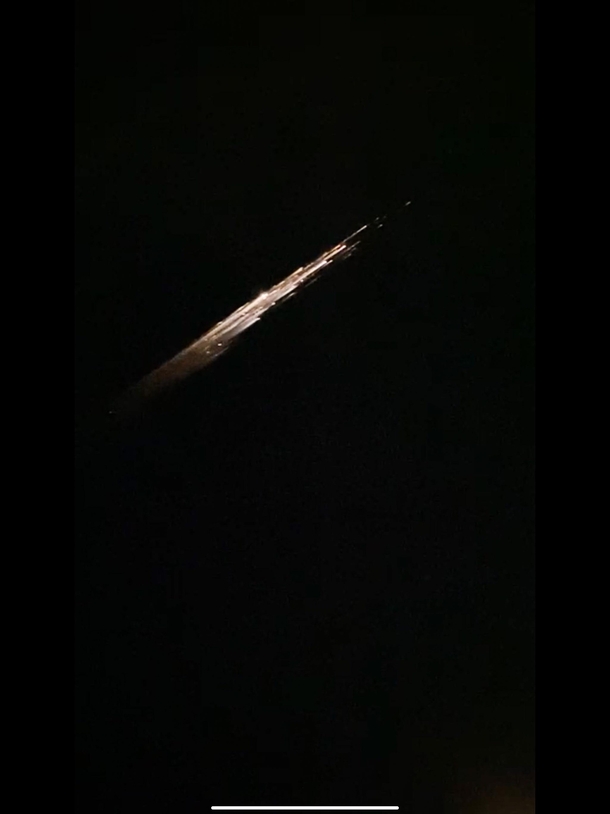 Saw this in person right after coming out of Target I took this photo out of an iPhone  video so its not very high quality I still wanted to share it because it was beautiful and profound to see Apparently it was a piece of falcon  debris