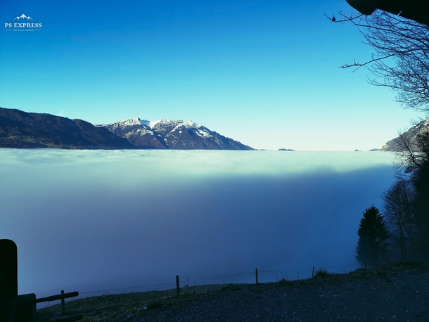 Sea of fog and a blue sky swiss mountains 