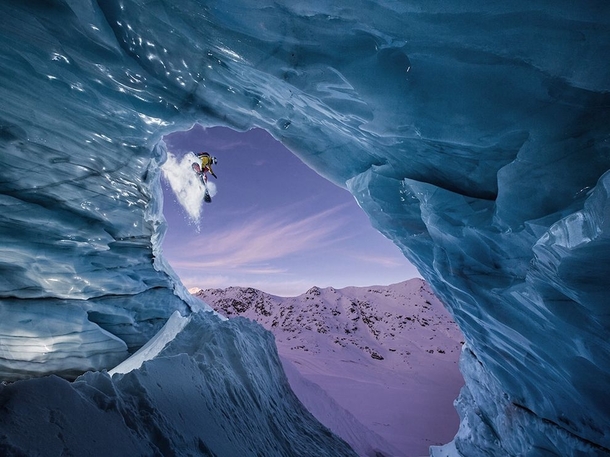 Snowboard jump shot through an ice cave in Austria photo by Christoph Jorda 