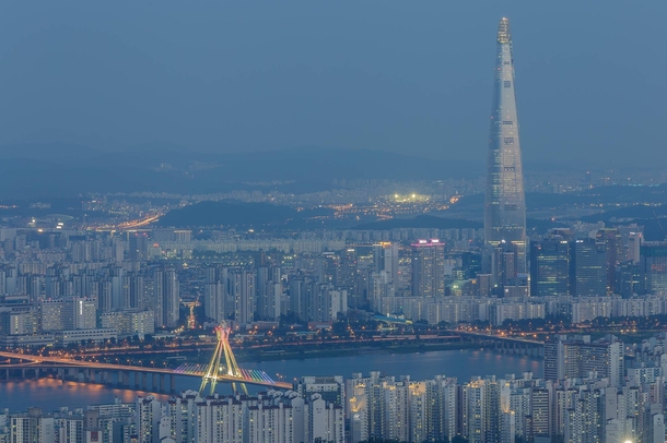 Songpa District at night with the Olympic Bridge at the foreground and the Lotte World Tower on the right Seoul South Korea 