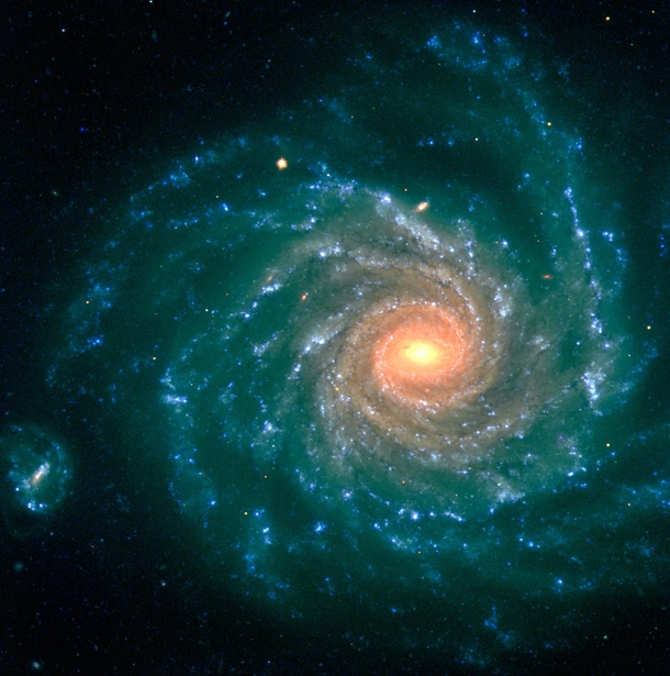 Spiral Galaxy NGC  - The central region contains older stars of a reddish color while the spiral arms are populated by young blue stars and star-forming regions 