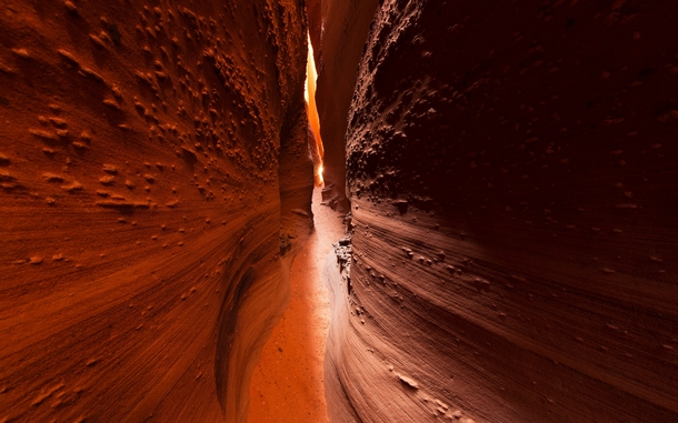 Spooky Canyon a narrow slot carved into the orange sandstone of southern Utah The reflected light is intense when the sun is directly overhead 