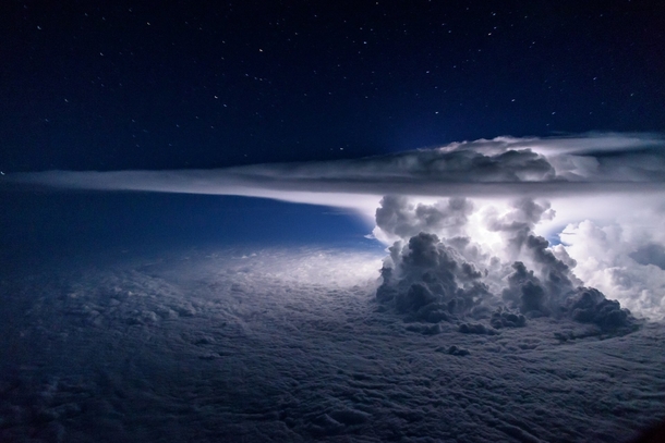 Stars Lightning Clouds -- A developing thunderstorm climbs high into the atmosphere over the Pacific Ocean south of Panama Photographer Santiago Borja 