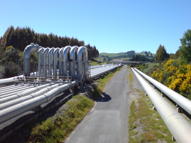 Steam pipelines leading from a steamfield near Lake Taupo to the geothermal power plant at Wairakei Region of Waikato New Zealand 