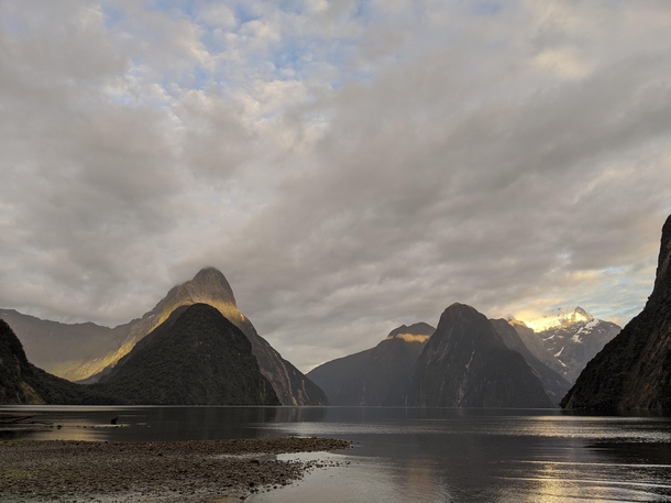 Sun breaking the cloud cover at Milford Sound New Zealand 