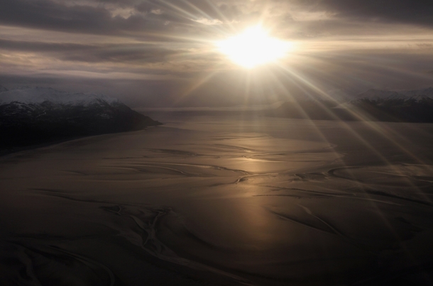 Sun coming through the clouds over Turnagain Arm in Alaska 