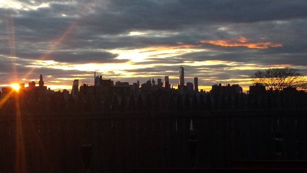 Sun Setting Behind the Manhattan Skyline Taken From a Roof in Brooklyn 