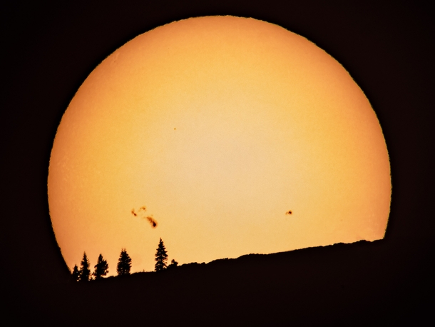Sun with Sunspots Visible Setting Over a Mountain in Northern California Through My Telescope 