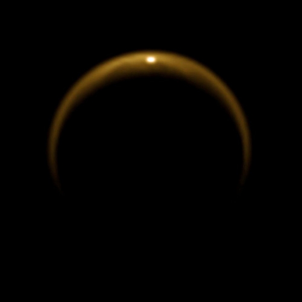 Sunlight reflecting off the surface of a methane lake on Titan one of Saturns moon