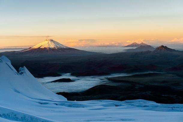 Sunrise from Volcan Antisana looking towards a smoking Cotopaxi 