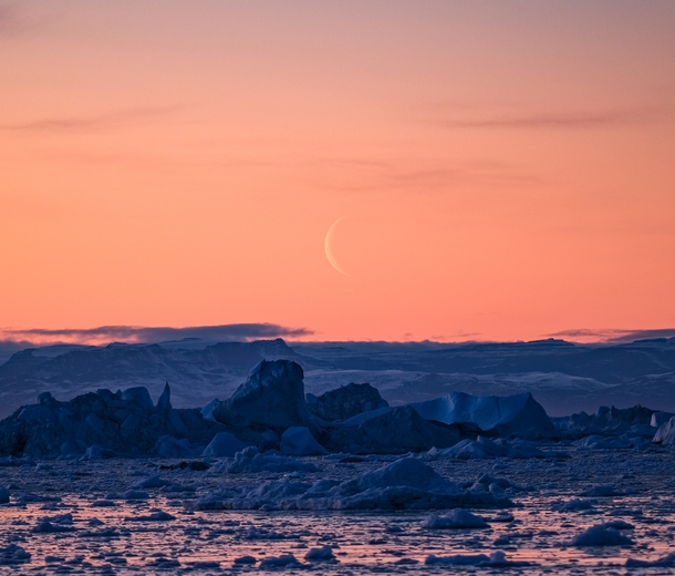 Sunset Icebergs and the Moon in Ilulissat Icefiord Ilulissat Greenland 