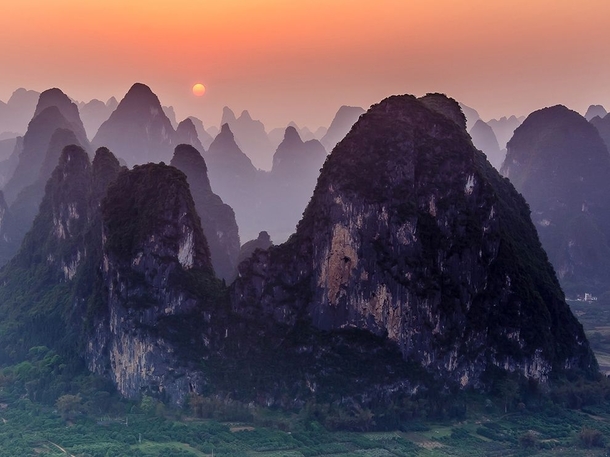 Sunset over the mountaintops of Xingping China Photo by James Bian 