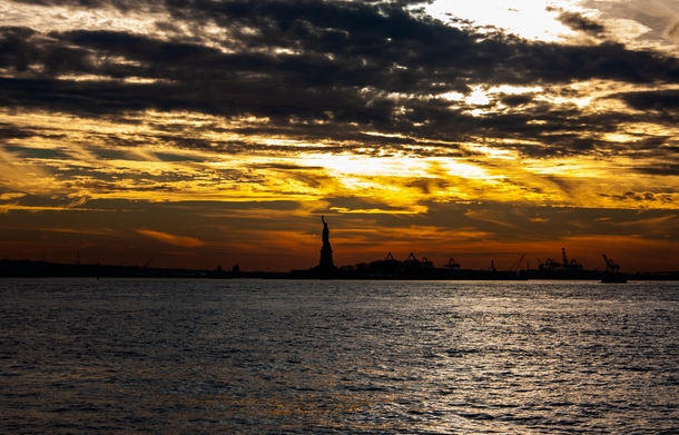 Sunset over the Statue of Liberty last December oc