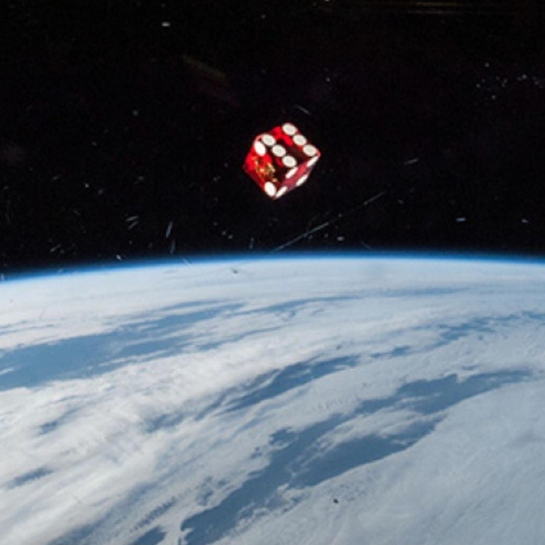Taken shortly after arriving at the International Space Station as a member of Expedition  NASA astronaut Reid Wiseman snapped this photo of a die floating in front of one of the windows in the Cupola of the orbiting outpost