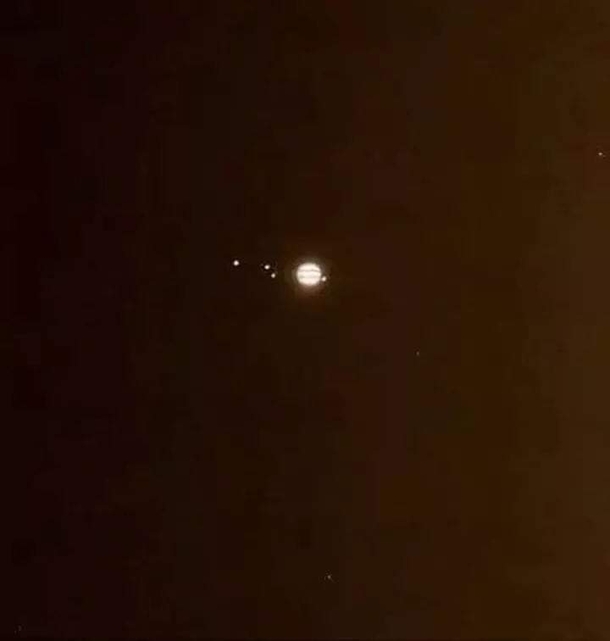 Telescope view of Jupiter and its Galilean moons