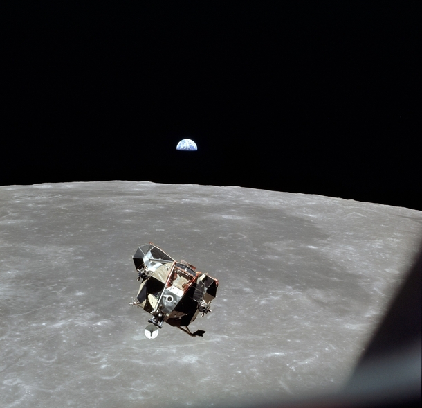 The Apollo  Lunar Module approaching the Command Service Module with an Earth rise for good measure