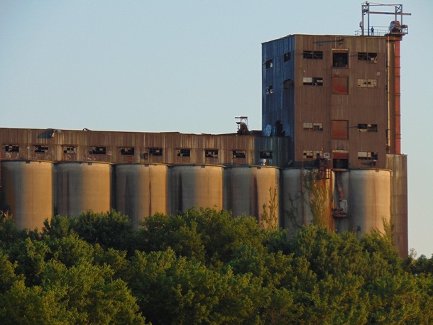 The Central Soya Plant stands alongside the Tennessee River in Chattanooga Tennessee I took this picture last year while on a riverboat cruise Can you spot the guy standing on top of the building