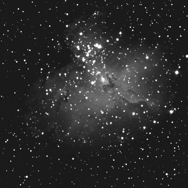 The Eagle Nebula with the pillars of creation visible through a Unitron   refractor on black and white film