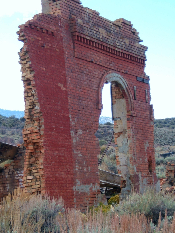 The front of a ruined bank in a ghost town in central Nevada 