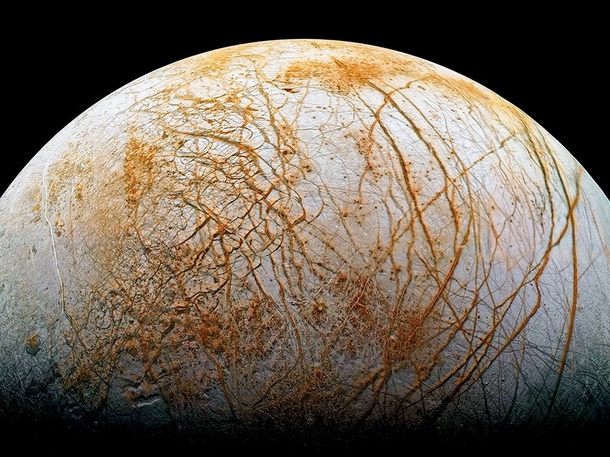 The frozen fissured surface of Jupiters moon Europa seen here in a colorized mosaic image from the Galileo spacecraft 