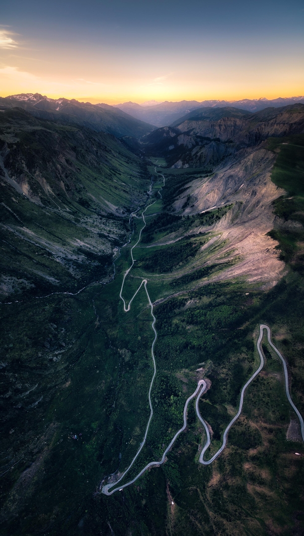 The Glowing Rift - The very last lights of the day in this aerial vertical panorama over the Valle des Villards road French Alps 