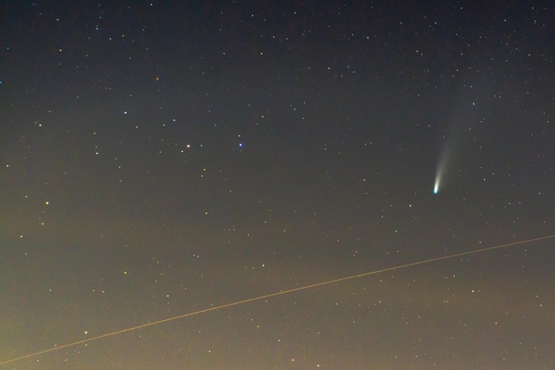 the International Space Station passing just below comet NEOWISE 