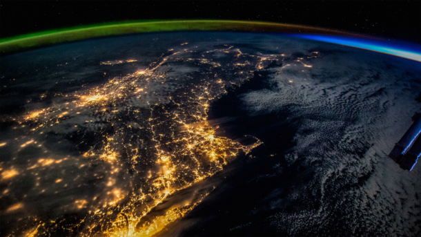 The International Space Station sails over New England at night capturing both the sunrise on the horizon and the aurora borealis 