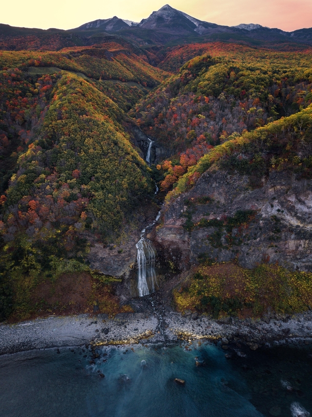 The Kamuiwakka Hot Falls of Shiretoko National Park just after sunrise Hot spring water coming out of the side of the active volcano Mt Shiretoko flows into the river turned waterfall 