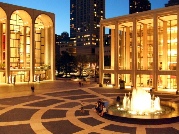 The Lincoln Center for the Performing Arts NYC at twilight The Metropolitan Opera House is to the left and Avery Fisher Hall to the right 