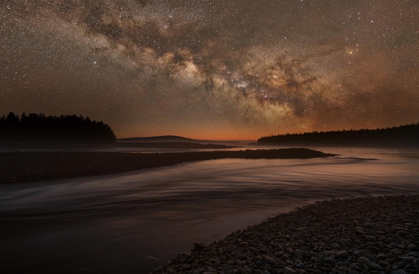 The Milky Way rises over an intertidal river in Acadia National Park Maine 