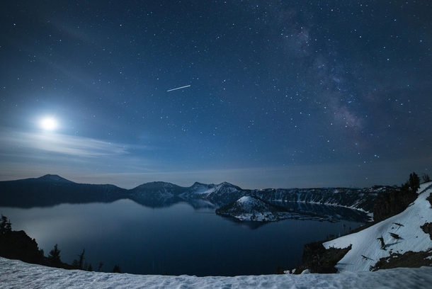 The moon and Milky Way rising over Crater Lake National Park Oregon USA 