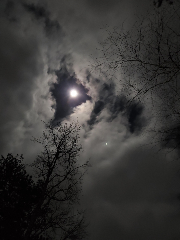 The moon on a windy night this week in the south east US Low clouds rolling through like a horror movie