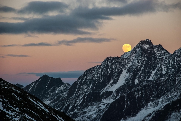 The moon rises over the Austrian Alps in Tirol 