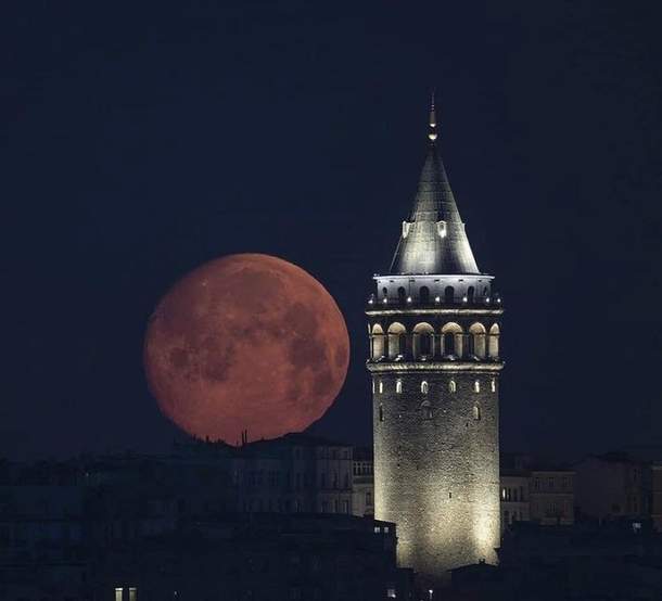 The moon seen from Istanbul next to the Galata Tower March 