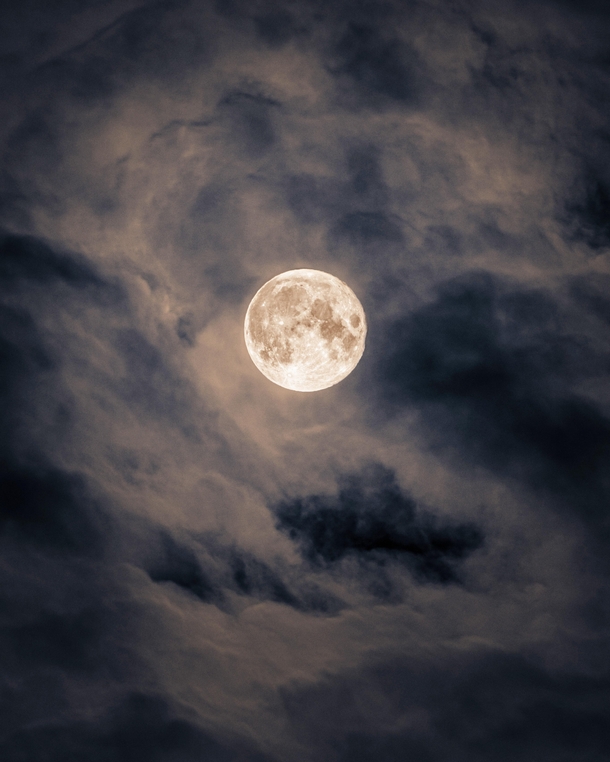 The Moon through a veil of clouds