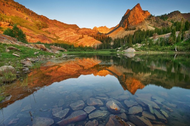 The mountains at Lake Blanche Utah bathed in golden light at sunset 