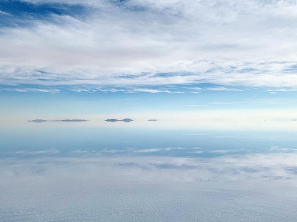 The perfectly reflective salt flat in Uyuni Bolivia makes it look like theres no horizon  x