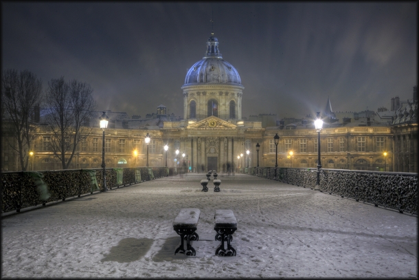 The Pont des Arts Bridge caked in snow  Photographed by Pascal