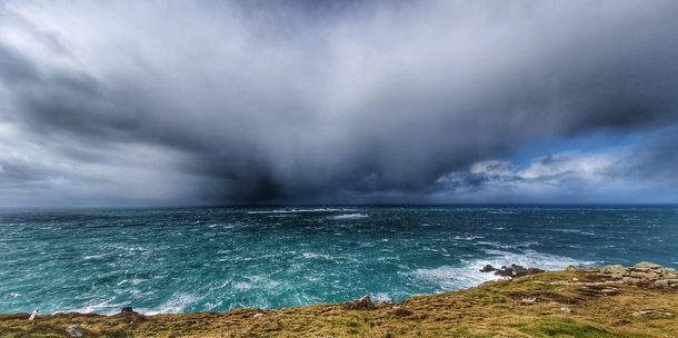 The rain is coming during storm Jorge at Lands End Cornwall UK 