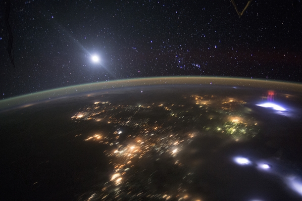The red sprite on the right over a brilliant white thundercloud and lightning discharge near the coast of El Salvador was photographed on  August  by an International Space Station astronaut orbiting high above Acapulco Mexico 