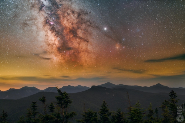 The shimmering light of the Milky Way rising high above the Adirondack Mountains on a cool hazy night 