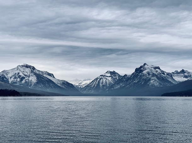 The snow capped mountains of Glacier National Park as seen from Lake McDonald OC x
