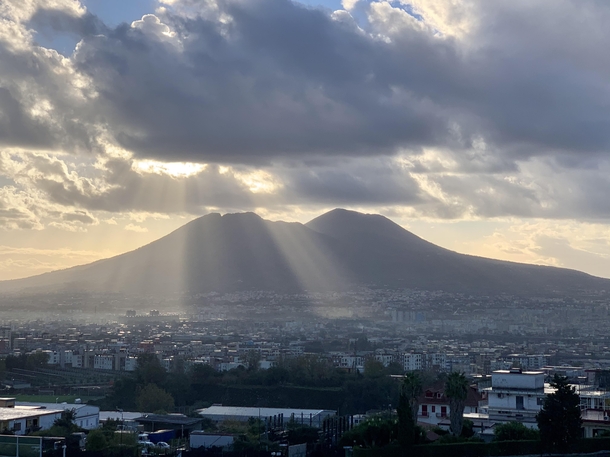 The sun breaking through over Mount Vesuvius Naples Italy