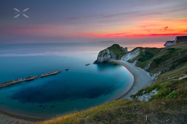 The Sun Sets on Beautiful Man of War Bay on the Dorset coast in England Photographer is SiewLam Wong 