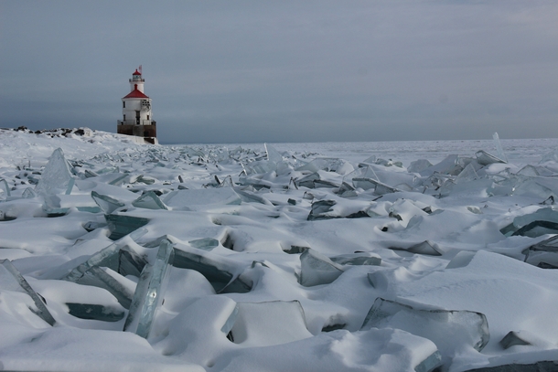 The Superior Wisconsin harbor entry lighthouse and frozen Lake Superior 