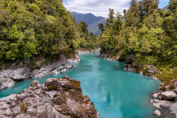 The vivid turquoise water of the Hokitika River rushes through a magnificent granite gorge lined with native bush  New Zealand by Jos Buurmans 